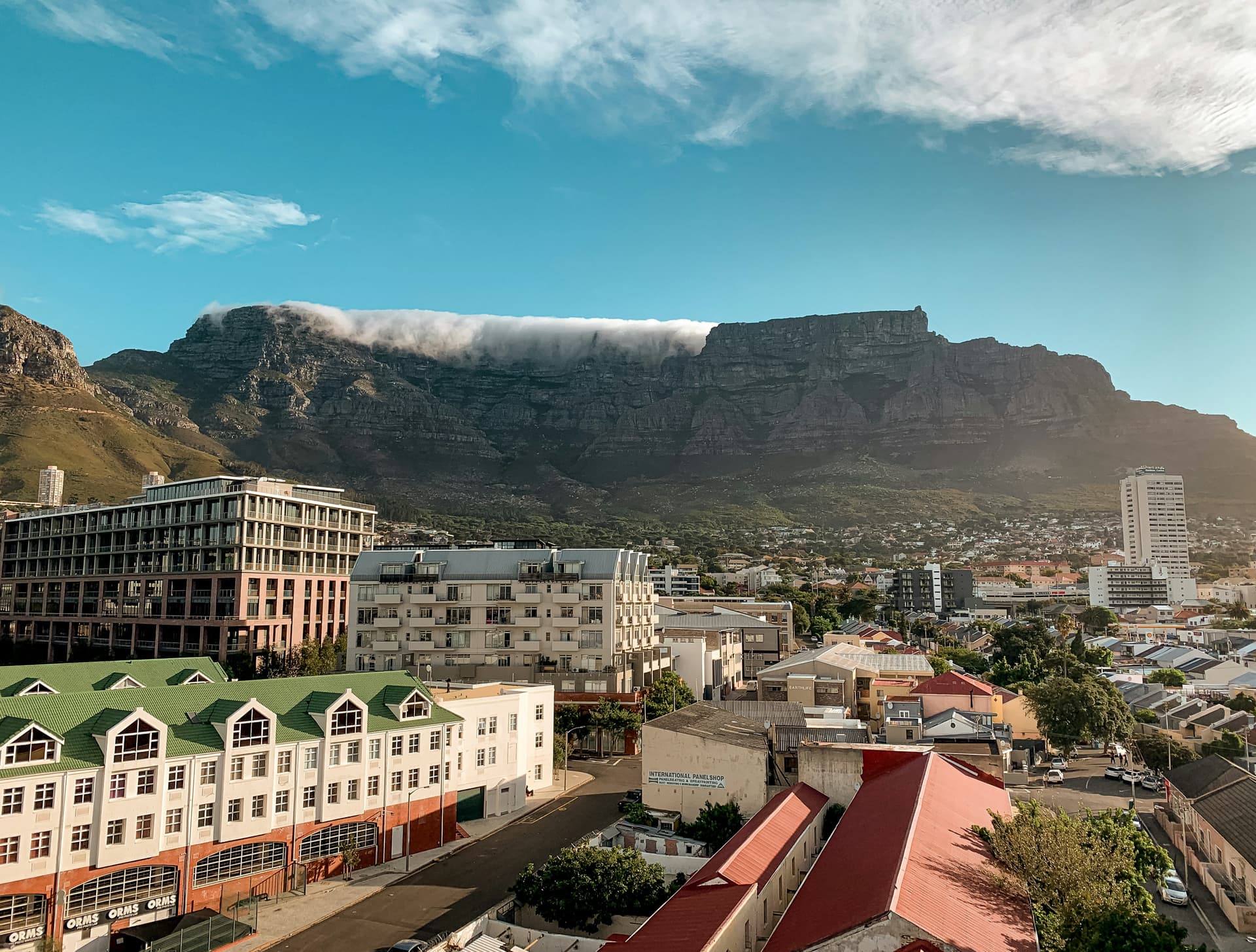 A summer sunset view of Cape Town's famous Table Mountain showing the "tablecloth" clouds that form when warm air moving up the slopes meets with the colder air at the top.