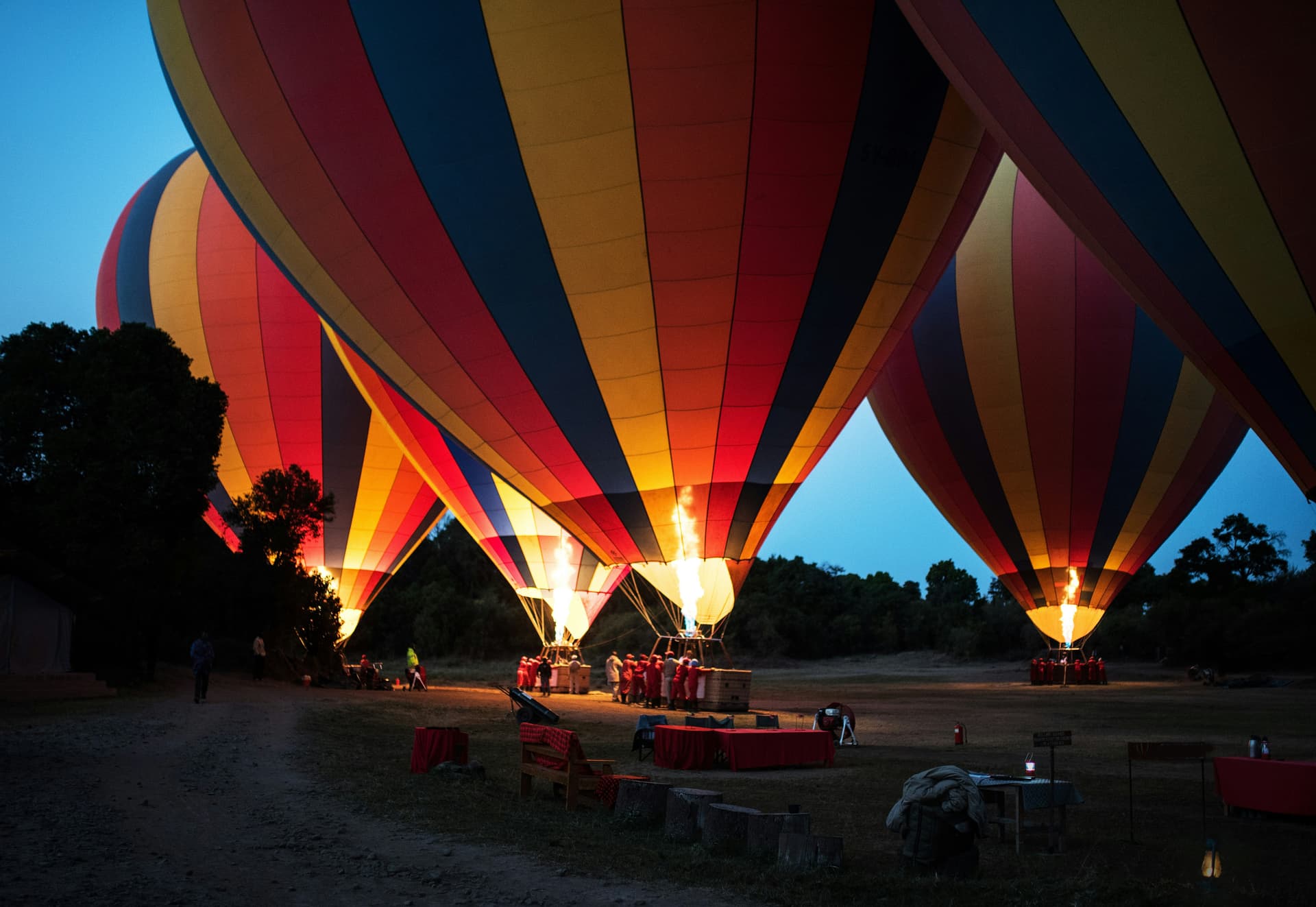 Early dawn at Little Governors camp, preparing hot air balloons, Masai Mara, Kenya.