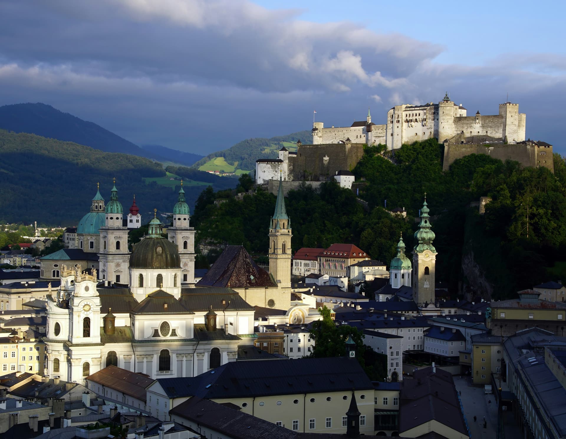 Panoramic view of Salzburg, Austria on a sunny summer evening with the old castle looming large in the background.